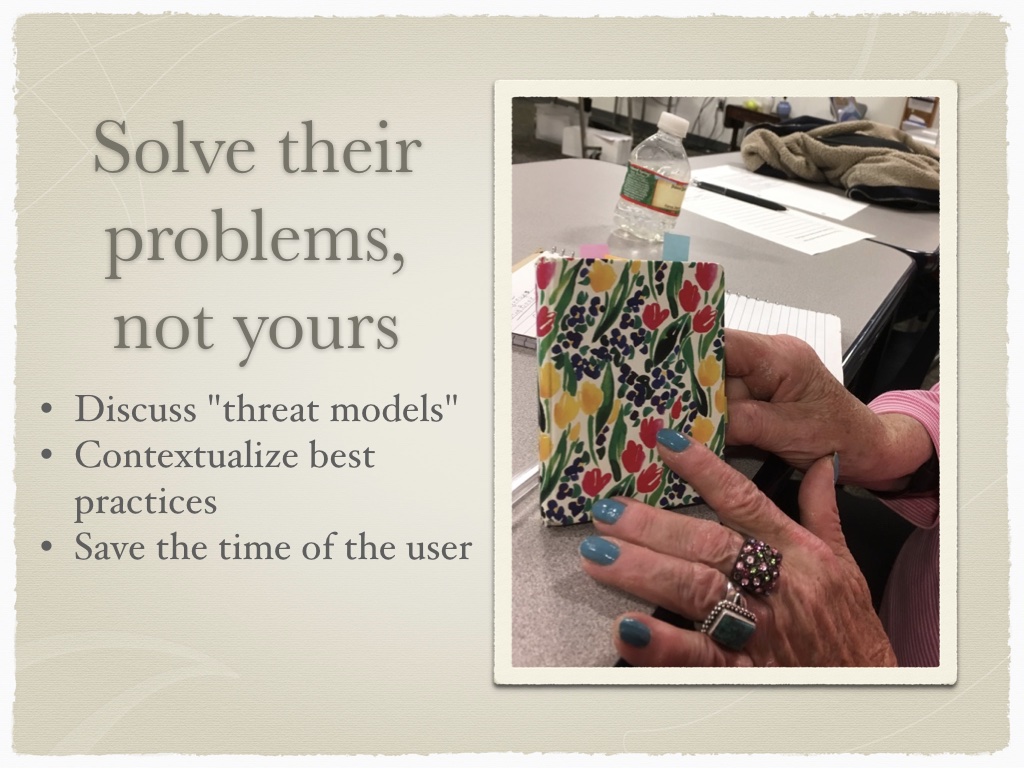 WOman's hands with fancily done nails holding a colorful small notebook. Headline 