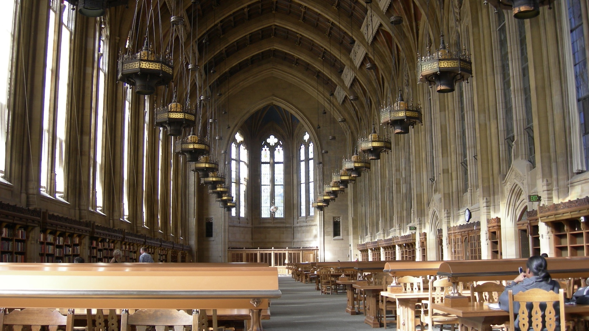 Glorious old school library with huge vaulted ceiling a lot of wooden tables, very majestic