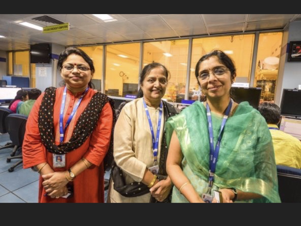 Slide 22: two images, one that was an iconic news image of women in saris celebrating and one that is an image of three different women in saris looking into the camera