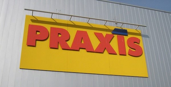 sign that says PRAXIS in big letters on the side of a building