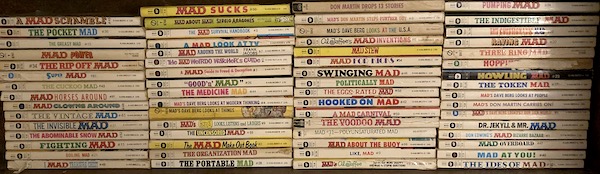 s shelf with MAD paperback books of various titles