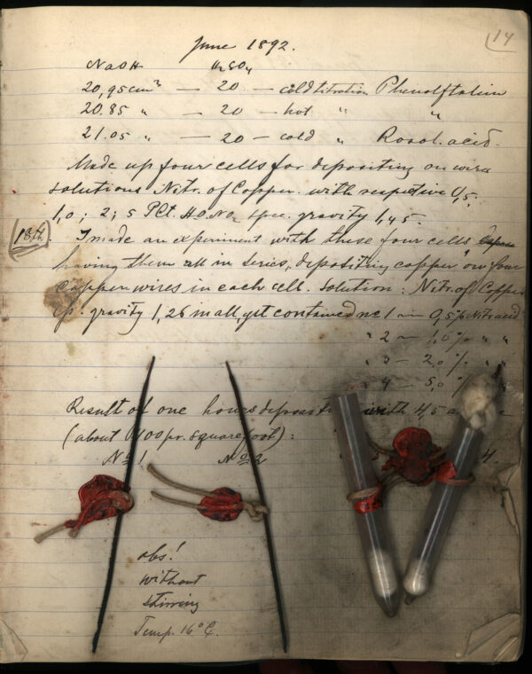 a handwritten document with some red wax seals on top of it.